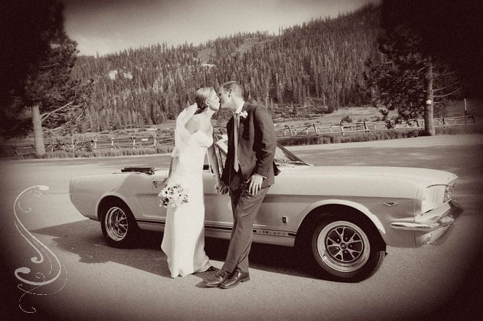 Katie and Warren share a kiss beside Warrens yellow Mustang convertible before heading in to their reception.