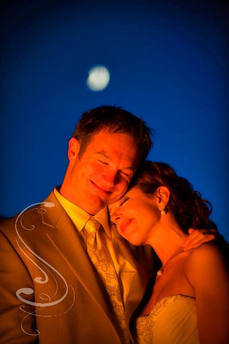 Kristen and Colin posed for a few late night photographs by the light of the fire on the bar deck with the moon in the background at Squaw Creek