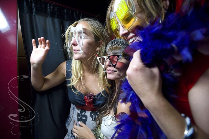 The bride and her girls ham it up inside the photobooth they rented for their reception