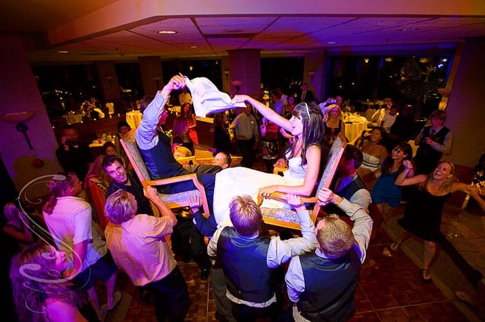 Robert and Michelle riding chairs during the hora at their wedding reception at Squaw Valley