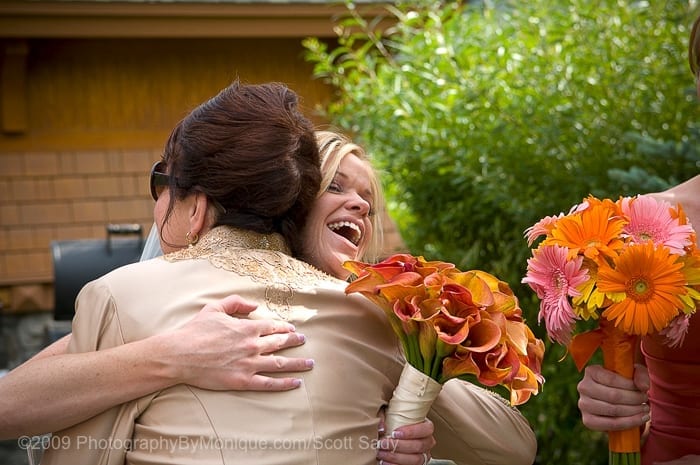 Sherry gets a big hug from her mom after sealing the deal in a wedding ceremony in the water garden at the Incline Village Hyatt