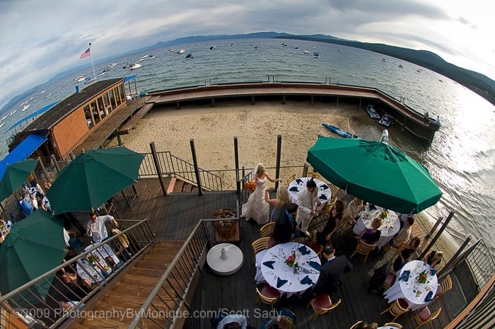 The outdoor dining and reception area of Captain Jon's shot with a fisheye from the balcony above.