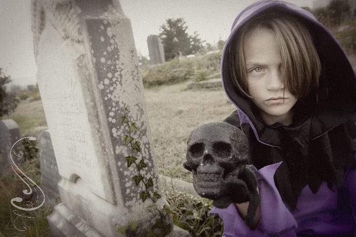 Nine year old Ethan Cleveland dressed as a phantom during a pre Halloween portrait session in the historic Coos Bay Pioneer Cemetery in Coos Bay, Oregon.