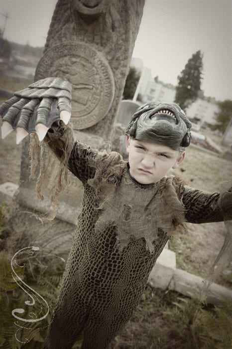 Seven year old Henly Cleveland getting into character as the swamp monster during a fun pre Halloween portrait session in the historic Coos Bay Pioneer Cemetery, in Coos Bay, Oregon.