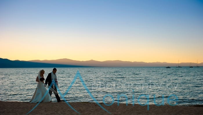 Bride and groom along the shore at sunset on Lake Tahoe
