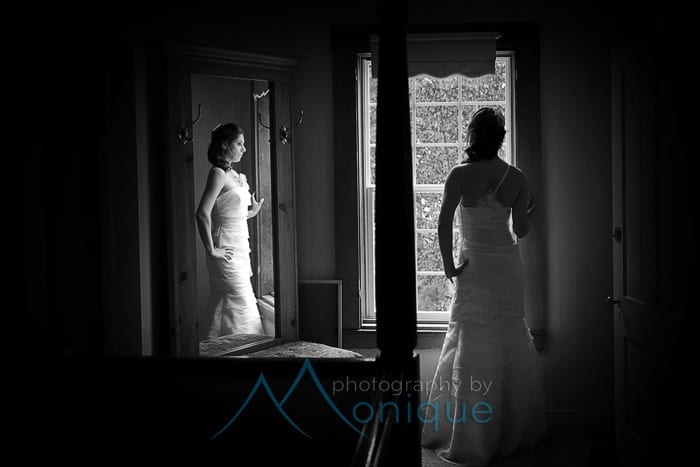 bride in dress at window