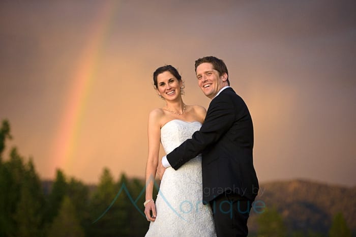 bride and groom with rainbow