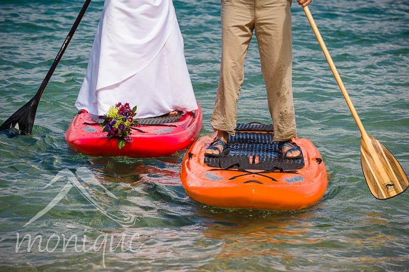 bride and groom and chacos on stand up paddle board