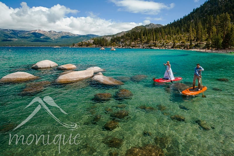 bride and groom on paddleboards on lake tahoe
