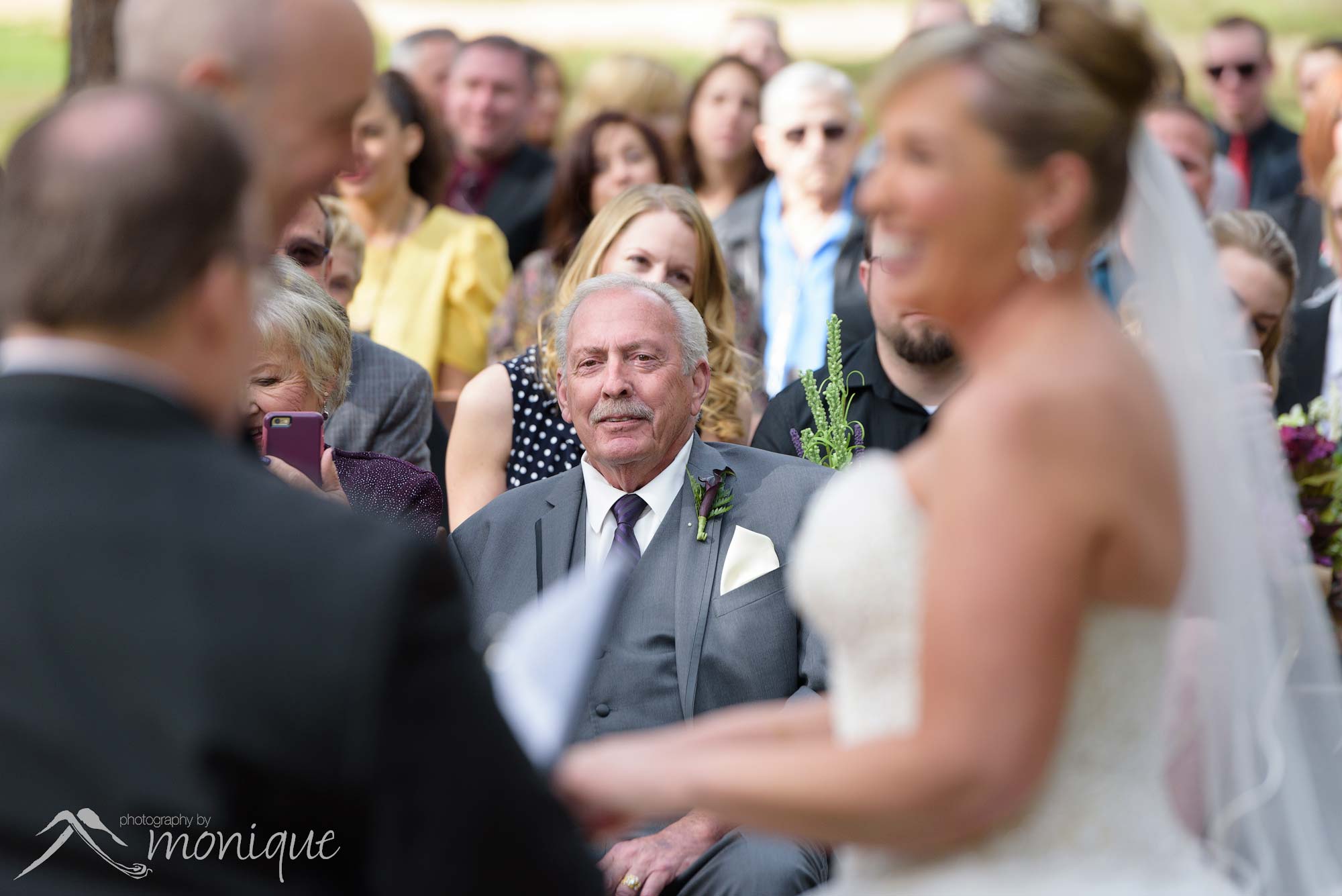 father watches bride get married