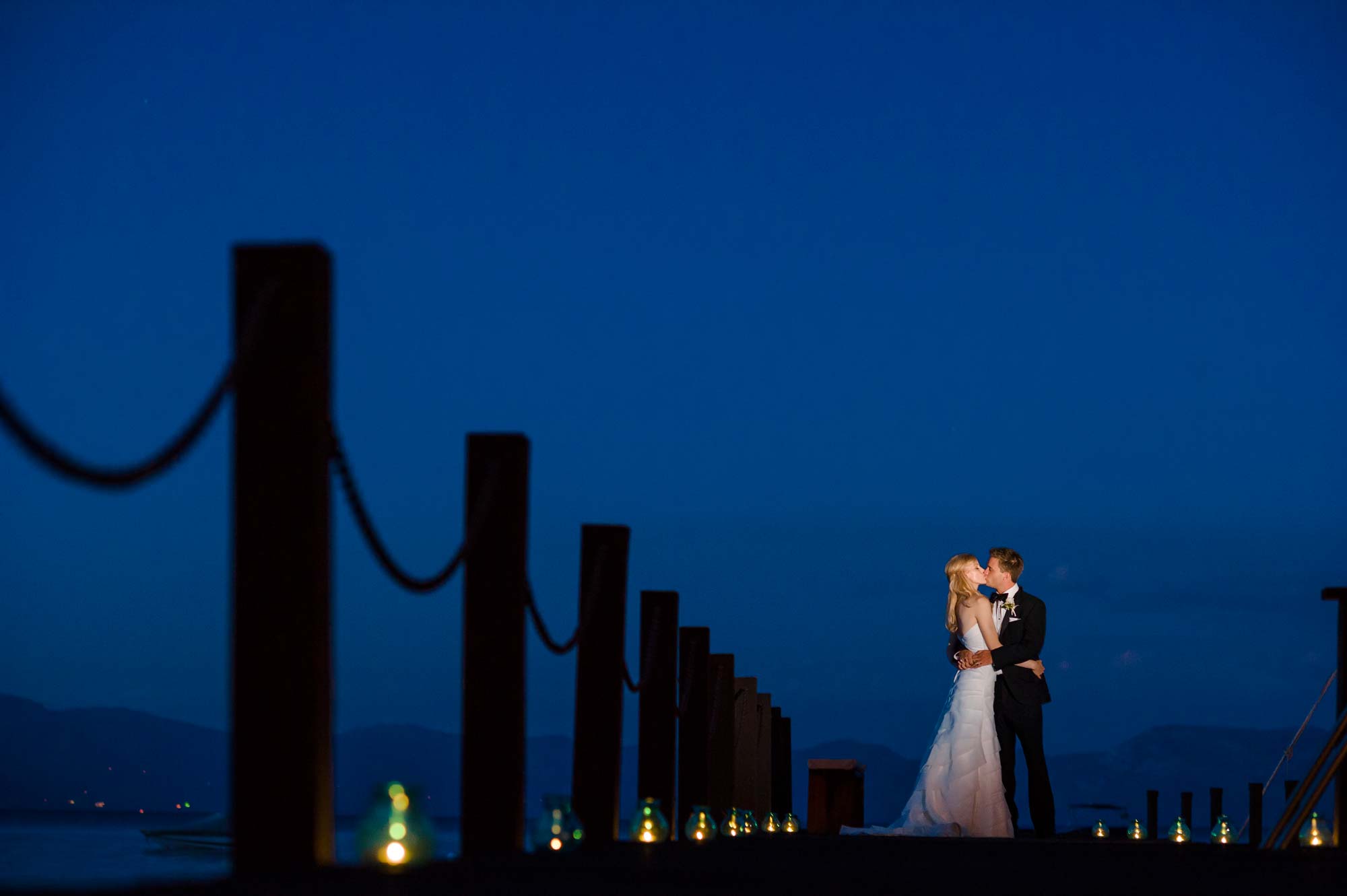 Photograph of bride and groom on pier at twilight during Lake Tahoe private estate wedding near Homewood, California. Photography by Monique, Lake Tahoe wedding photographer
