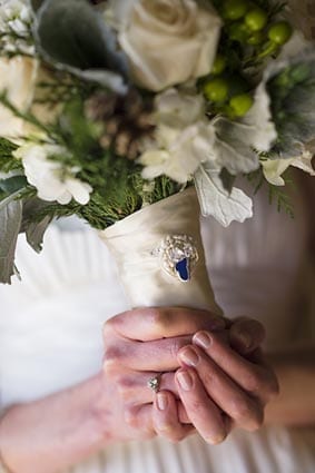 photo of a wedding bouquet with a Lake Tahoe pin on the wrap.