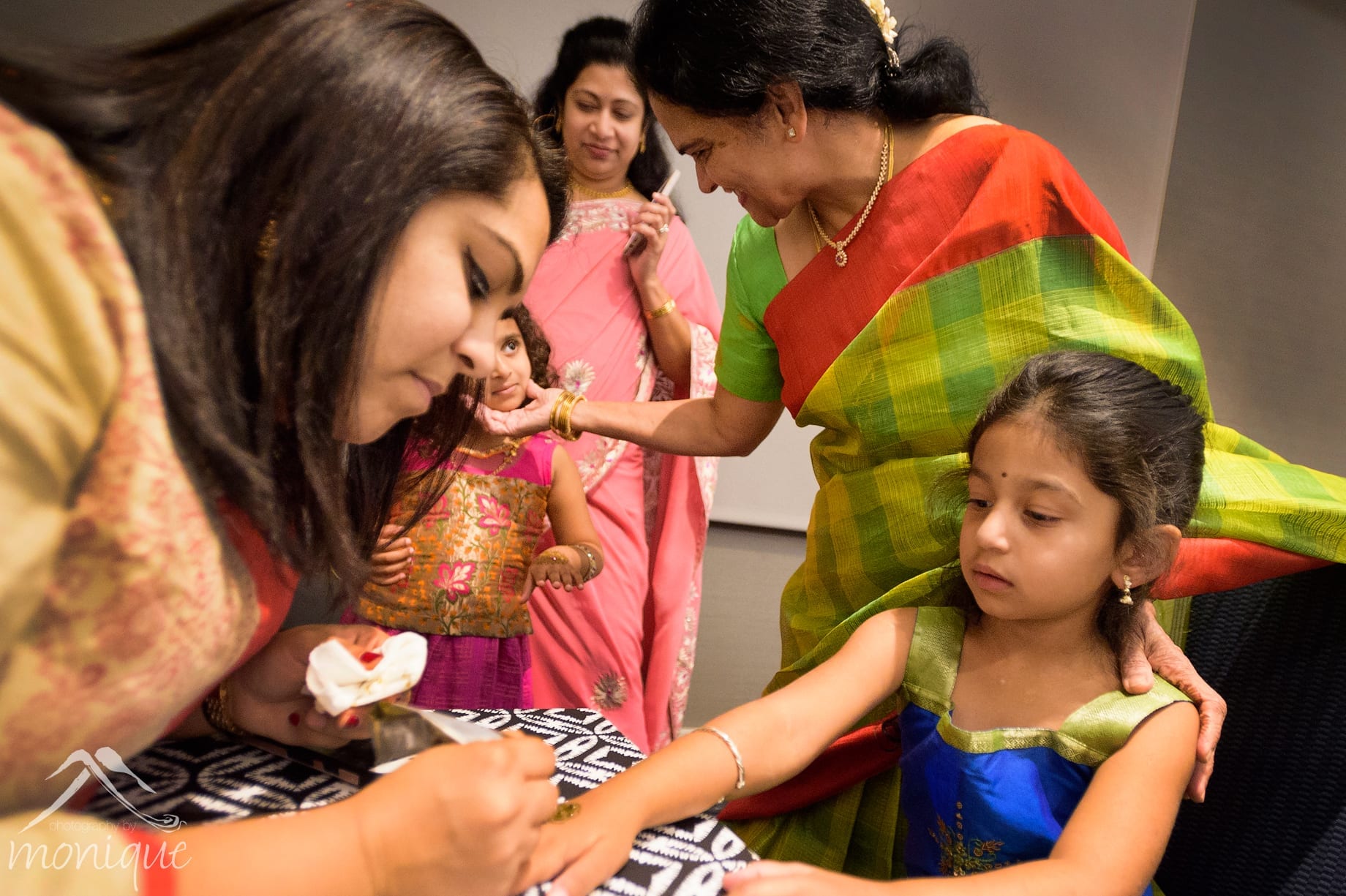 Bay Area Indian wedding photography during the sangeet with mehndi hand painitng for the guests