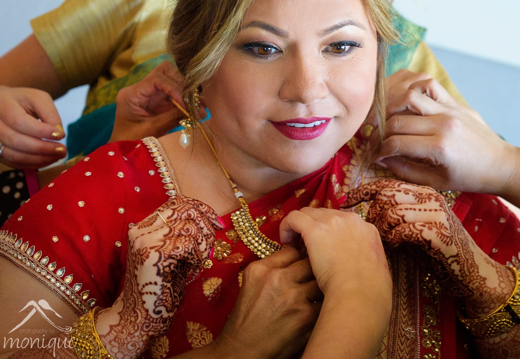 Bay Area Indian wedding photography with the bride getting ready with gold jewelry Photography by Monique
