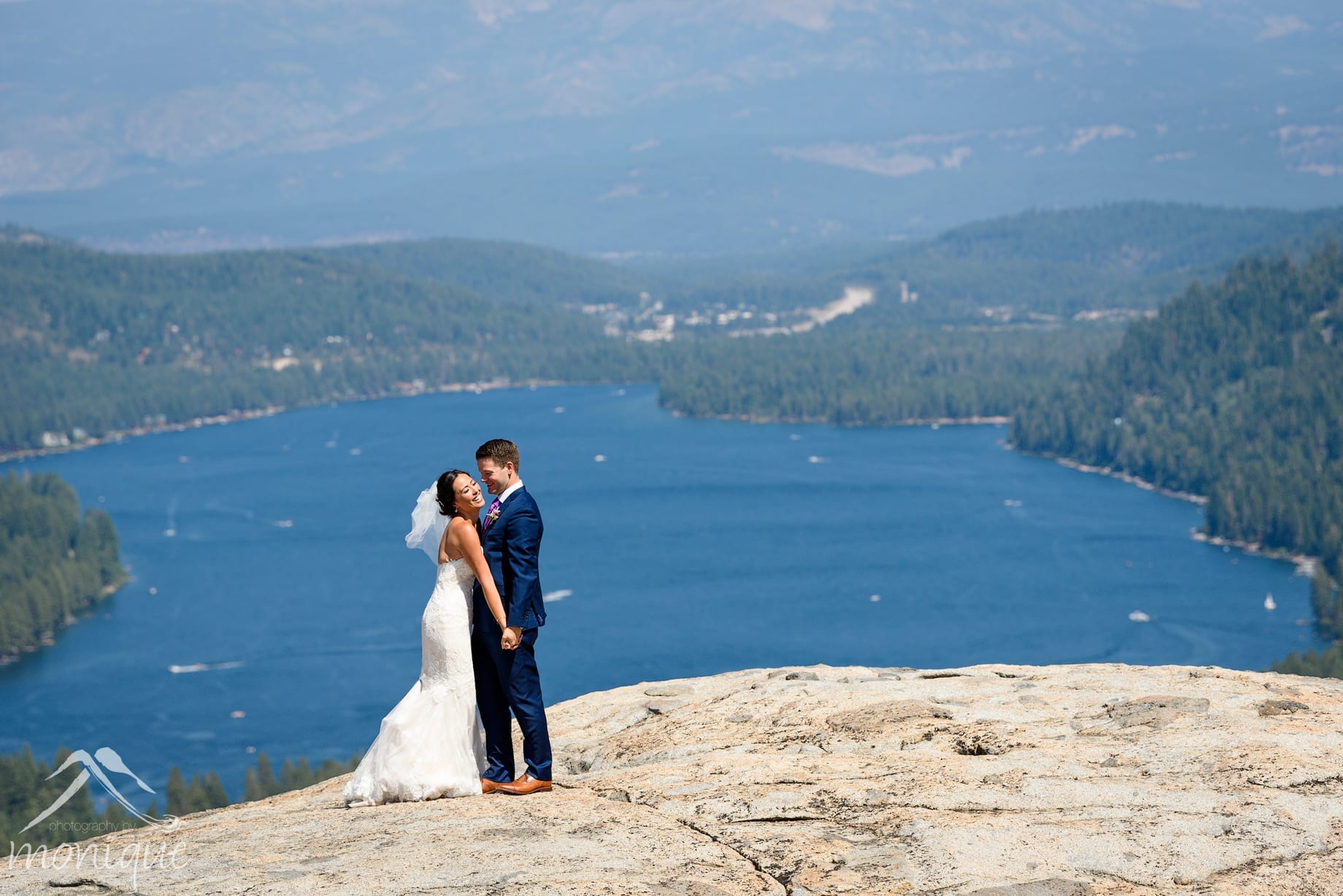 A bride and groom during their Truckee wedding photography session overlooking Donner Lake by Photography by Monique