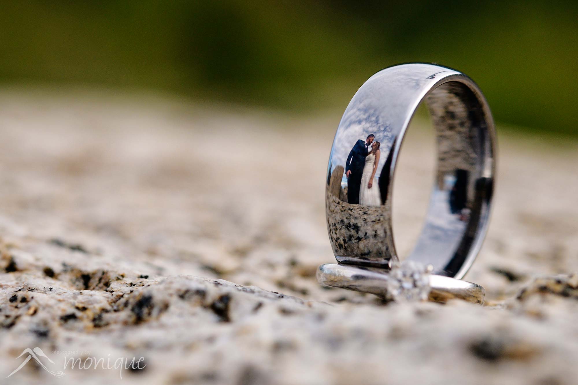 wedding portriat of couple reflected in rings