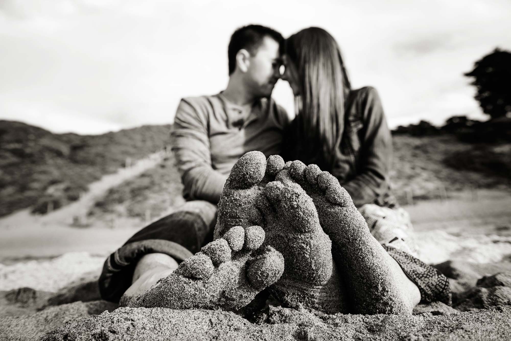 couple with bare feet in the sand