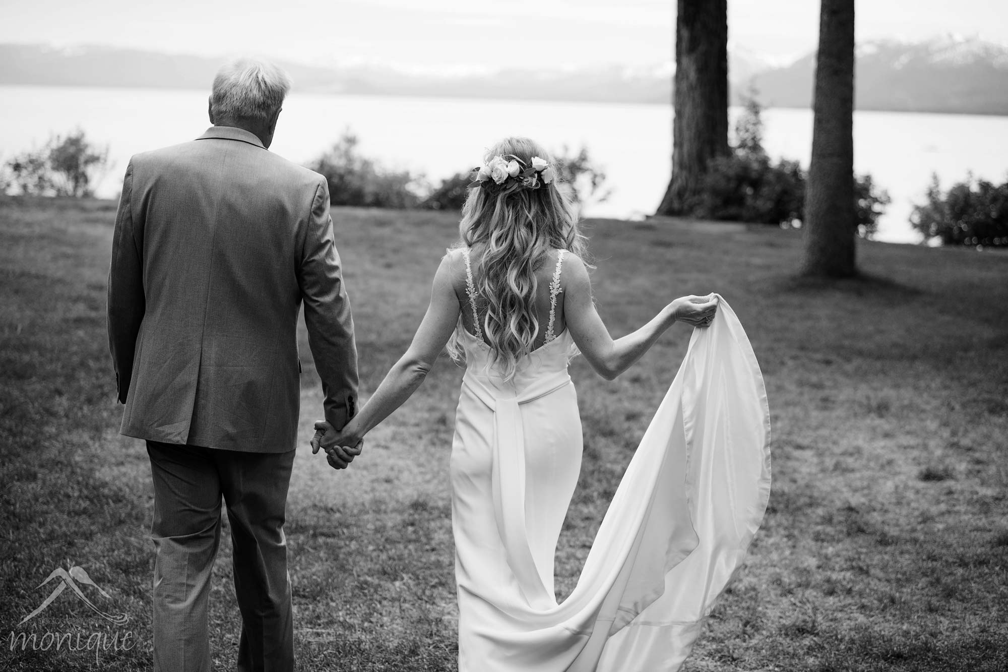 black and white image of bride and groom walking away