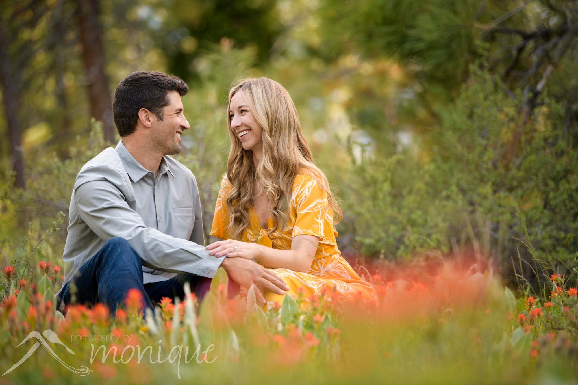 Lake Tahoe engagement session photography with the couple sitting in a field of wild flowers
