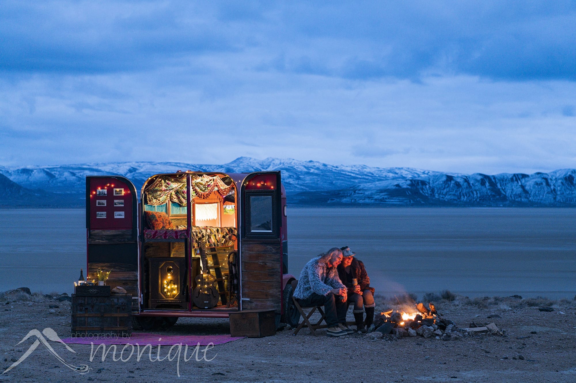 Boho vintage horse trailer camper with camp fire high above the Black Rock Desert