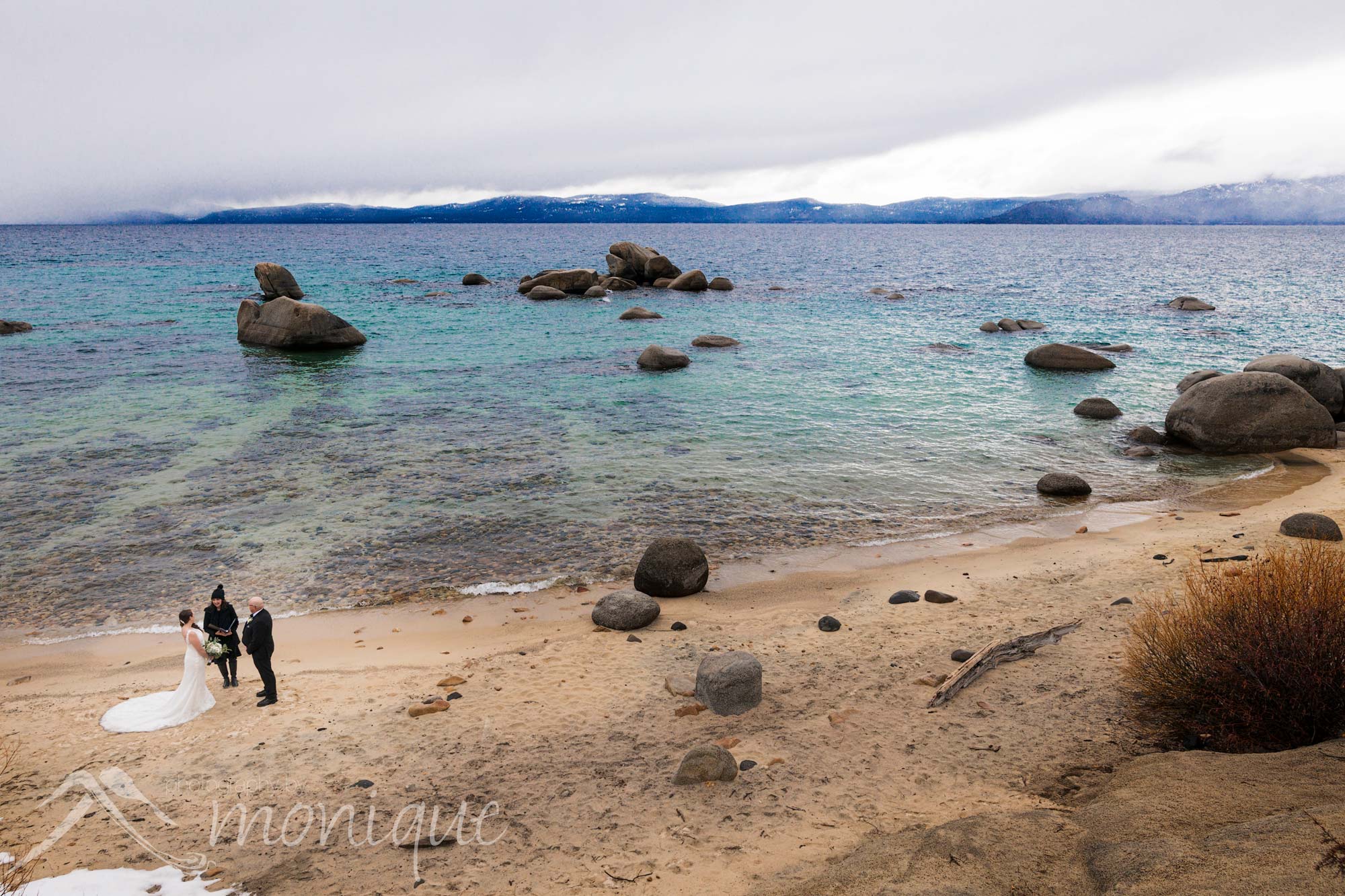 Lake Tahoe elopement photography overlooking the blue water at a secluded beach by Photography by Monique