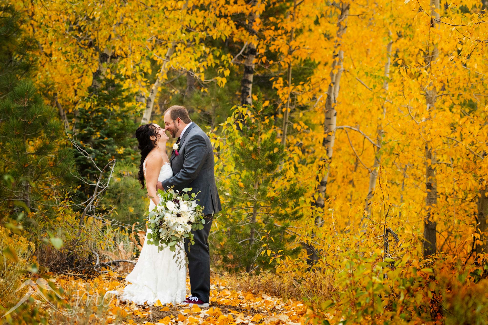 Palisades Tahoe wedding photography with a bride and groom in the forest of fall colors Photography by Monique