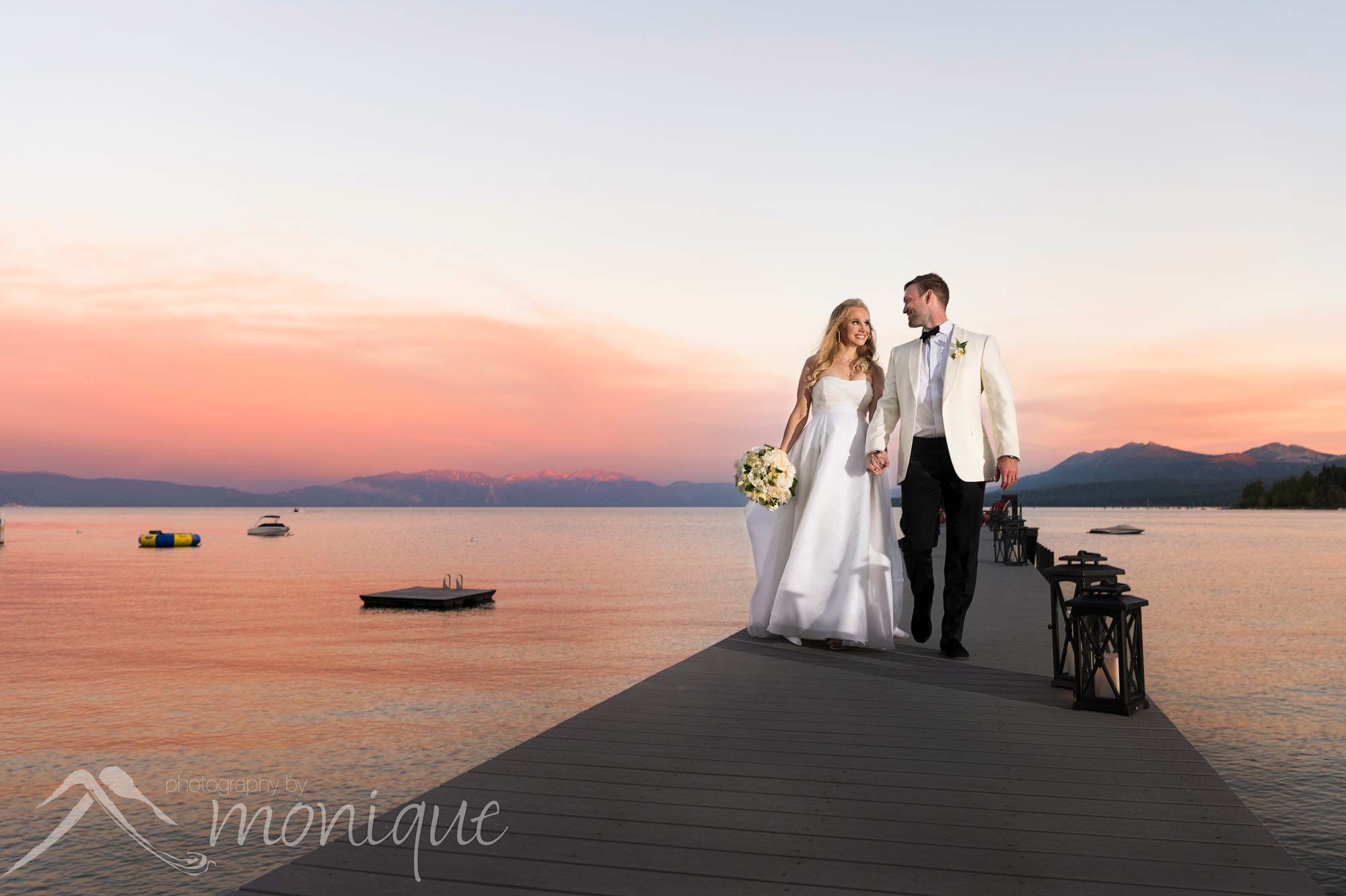 Lake Tahoe private estate wedding photography with the bride and groom Rachel and Bruce Taylor sitting on the pier at sunset, Photography by Monique