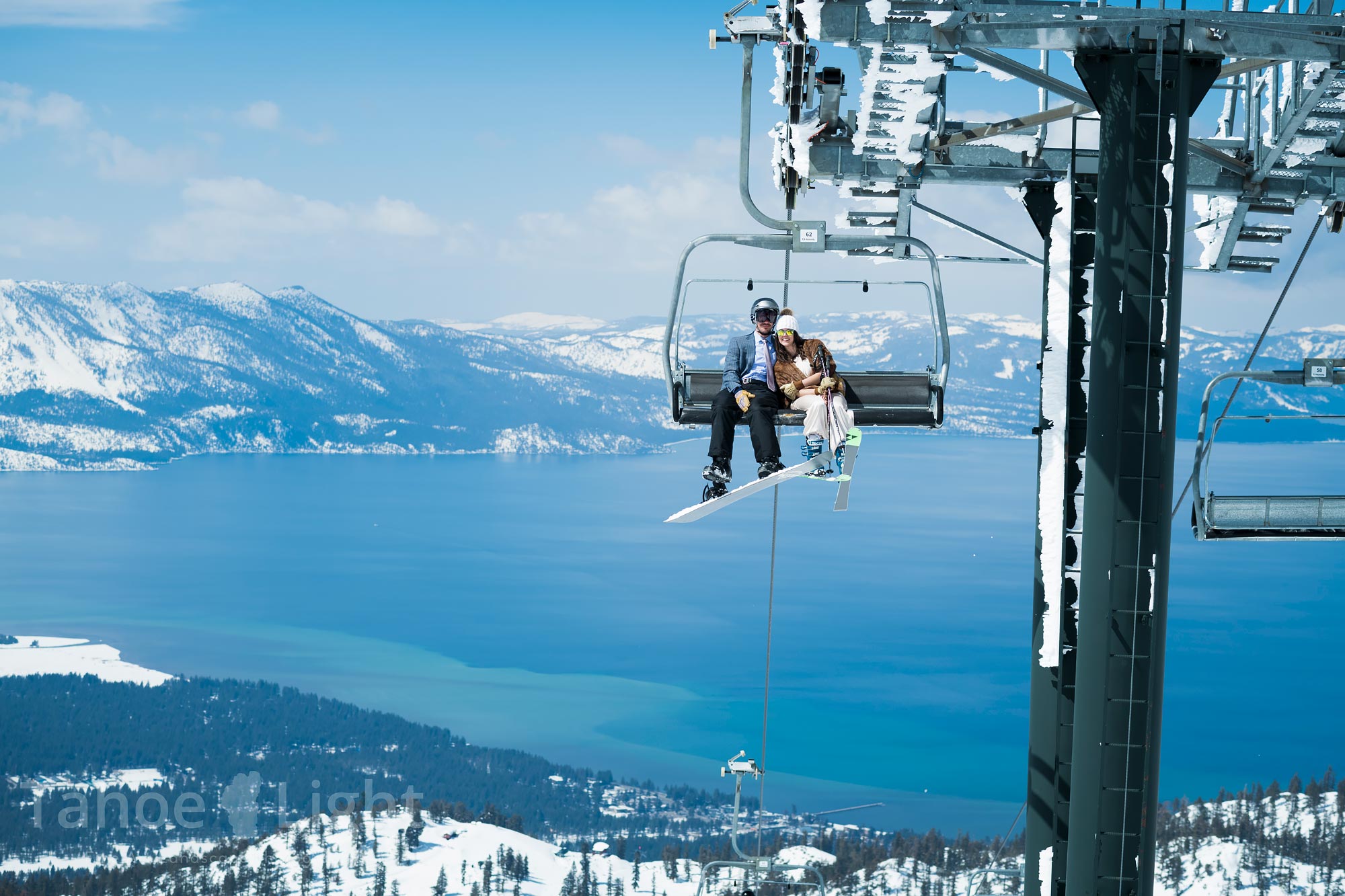 lake tahoe winter ski wedding couple riding chairlift with lake tahoe