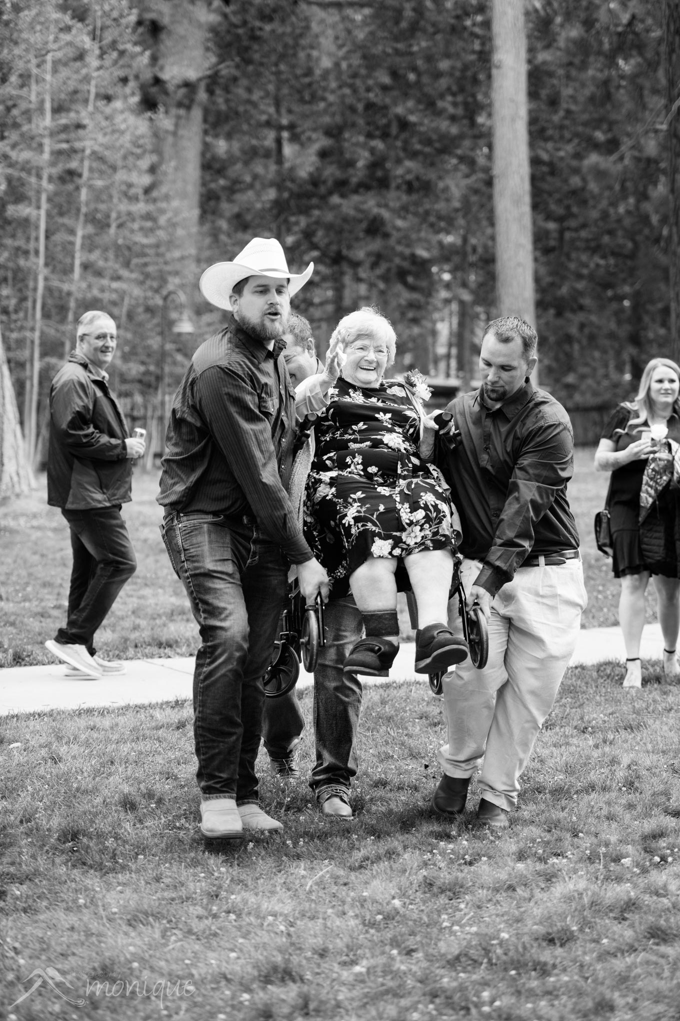 Elderly woman in wheelchair being carried at Valhalla wedding photography in South Lake Tahoe